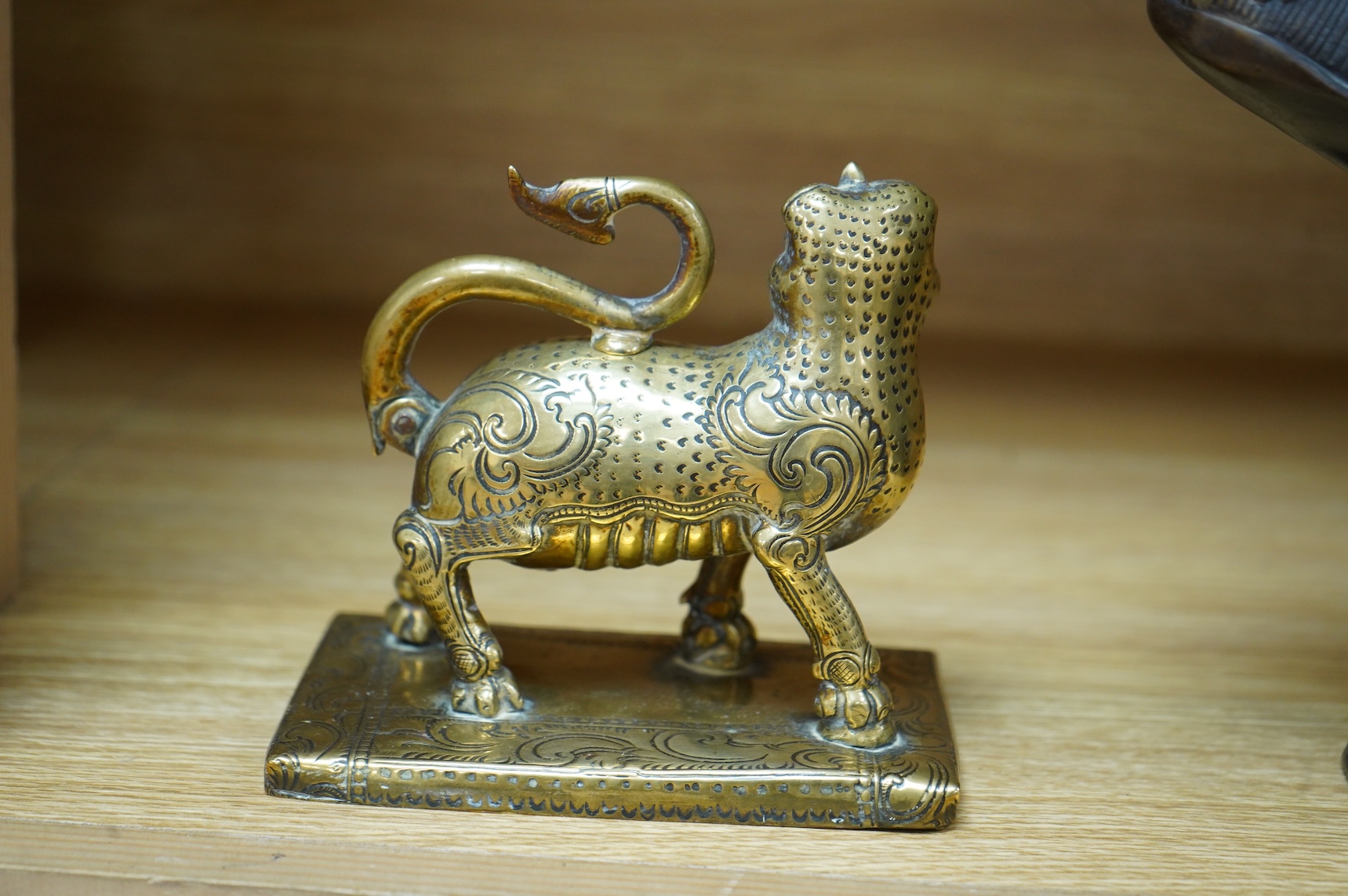 A 19th century south-east Asian brass incense holder in the form of a lion, 12cm wide
